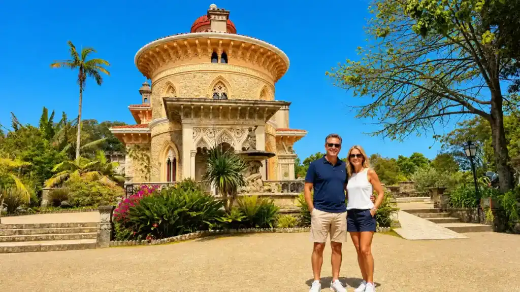 Couple posing in front of Monserrate Palace dome and carved facade, one of the beautiful places around Sintra