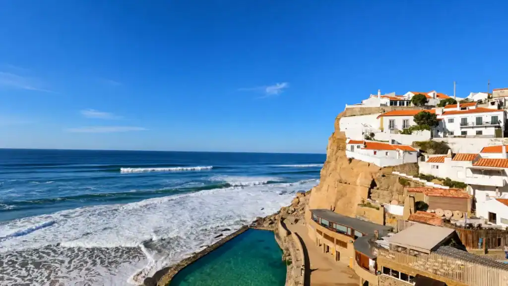 Whitewashed Azenhas do Mar clings to a clifftop above a turquoise tidal pool, among the best places in Sintra