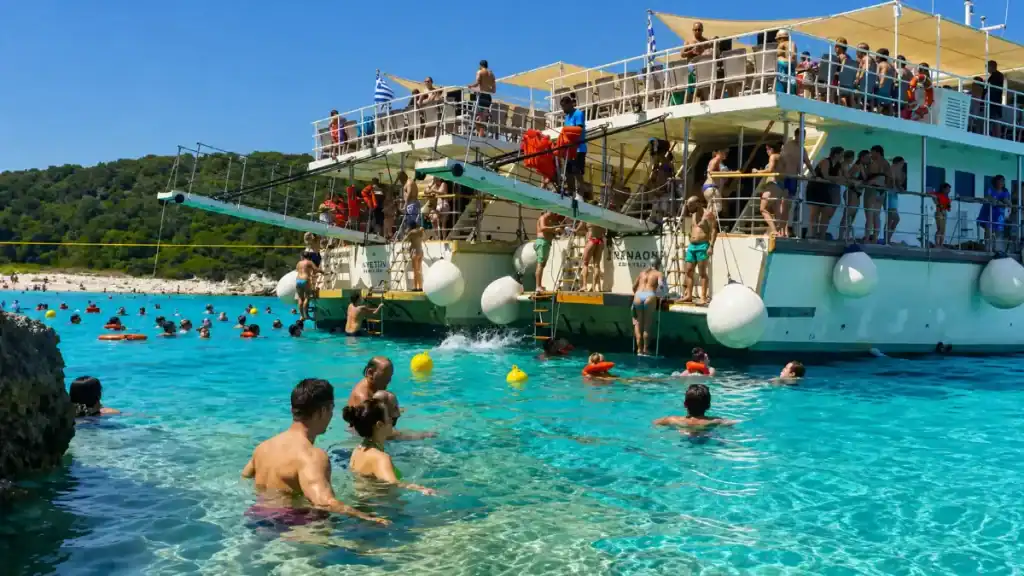 Passengers dive from a double-decker cruise boat near Antipaxos.