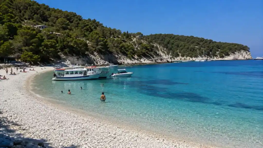 Swimmers wading into the turquoise waters of Voutoumi Beach on Antipaxos, a highlight for the best time to visit Paxos