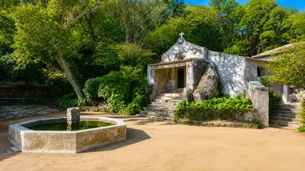 A small whitewashed chapel and stone fountain at the Convent of the Capuchos