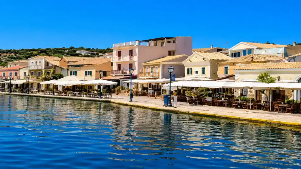 Waterfront cafes and pastel buildings line the promenade at Gaios harbour.