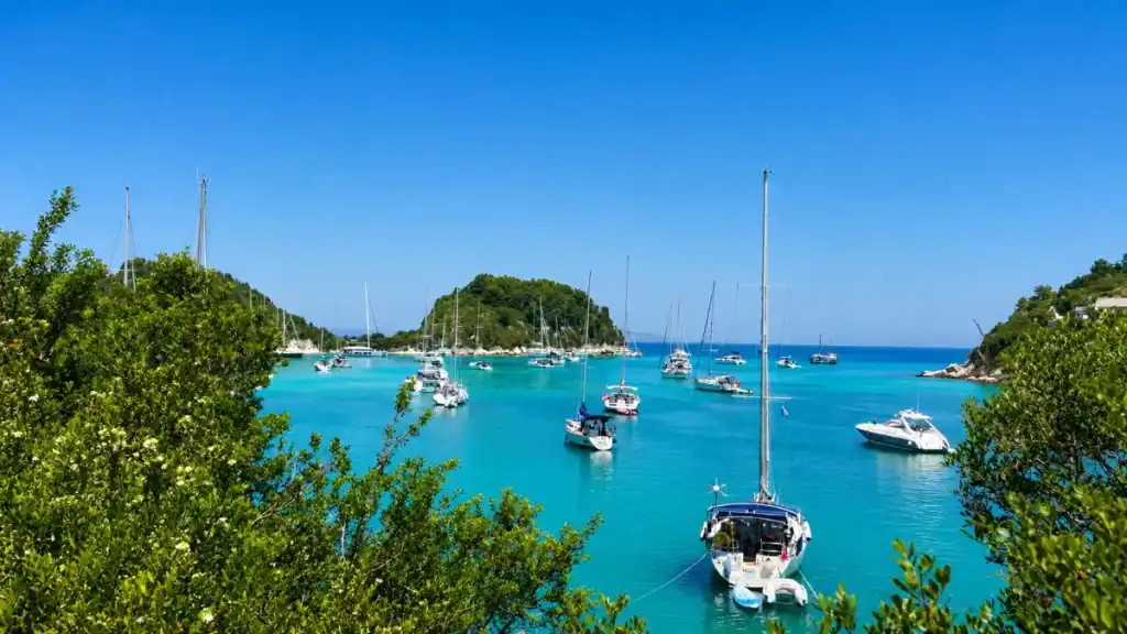 Sailboats anchored around the small islet in Gaios harbour entrance.
