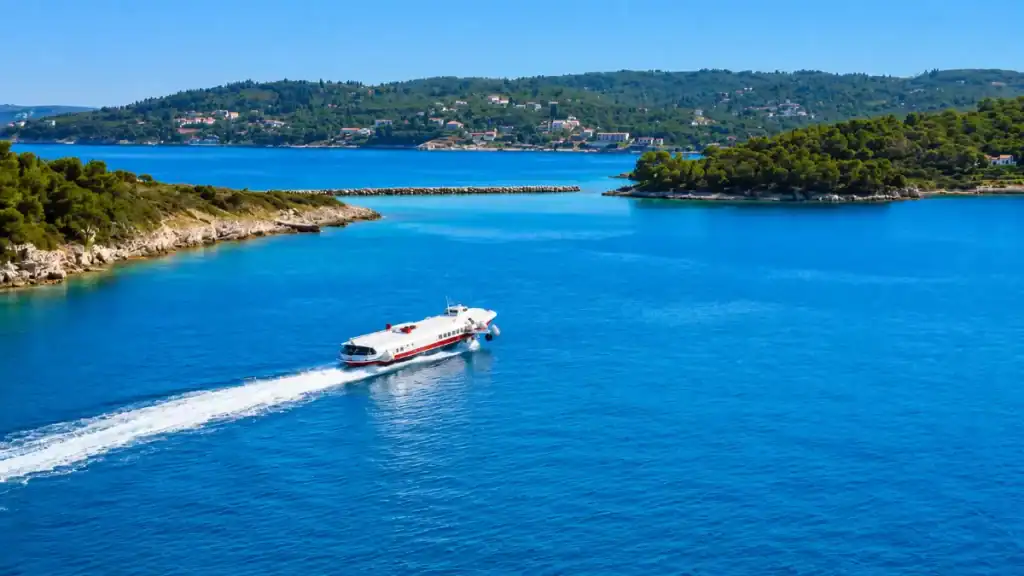A hydrofoil approaches the entrance to Gaios between Agios Nikolaos islet and the mainland.