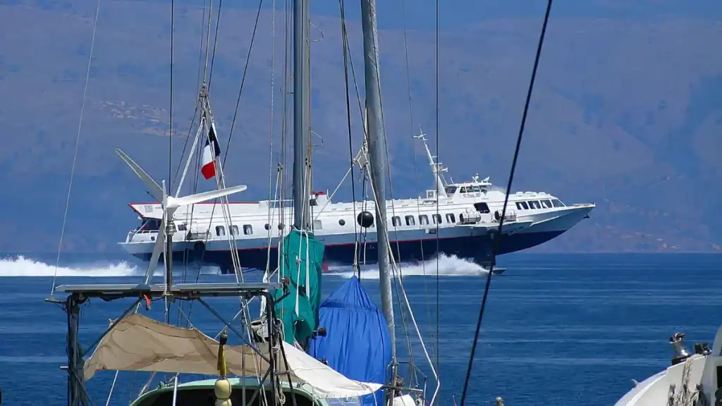 A hydrofoil speeds past yacht masts, another answer to how do you get to Paxos from the mainland.