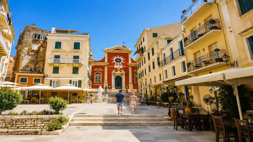 A couple crosses the square toward Agios Spyridon church in Corfu Old Town.