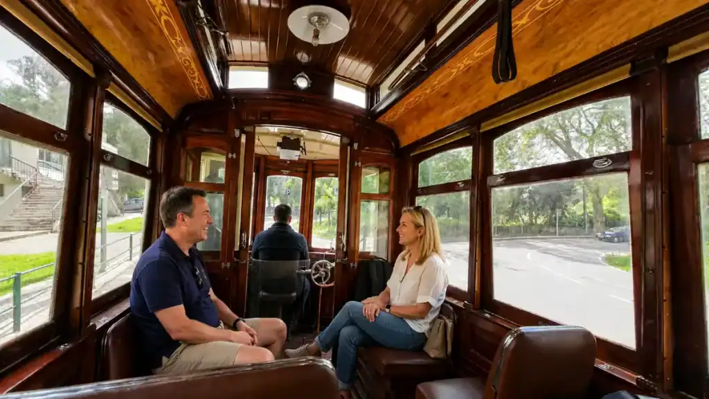 Passengers chat inside the wood-panelled tram heading to Praia das Maçãs.