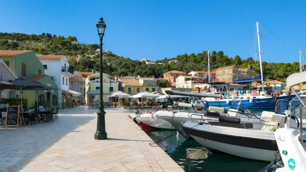 Speedboats and yachts moor along the stone quay in Gaios town