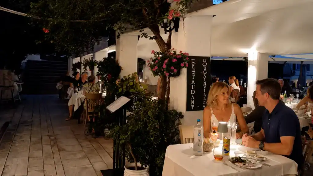 Diners share an evening meal at Restaurant Bougainvillea in Corfu's old town