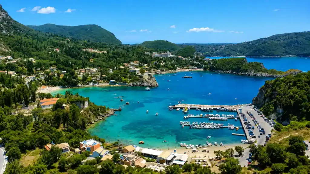 Boats fill the turquoise coves of Paleokastritsa beneath forested headlands
