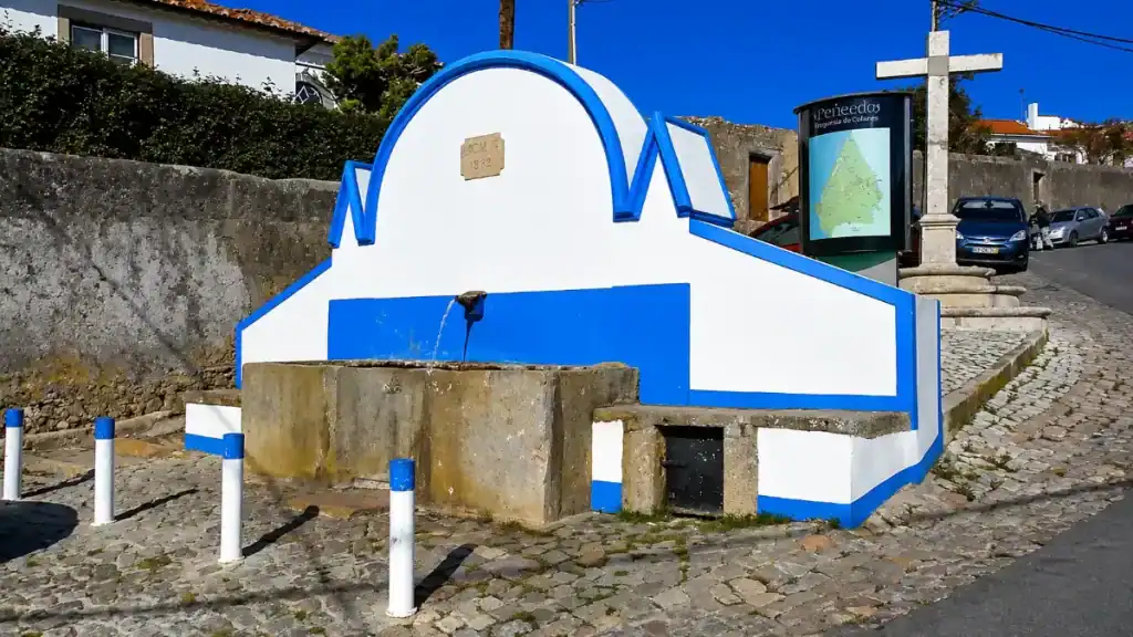 Blue and white tiled fountain marks the entrance to Penedo village.