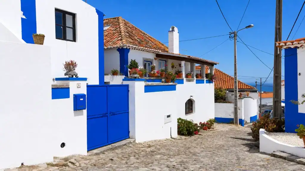Cobbled lane lined with whitewashed houses winds through Penedo.