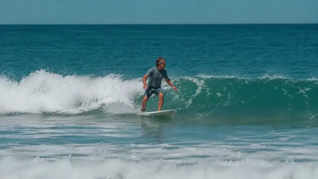 Surfer riding a clean Atlantic wave in a grey wetsuit