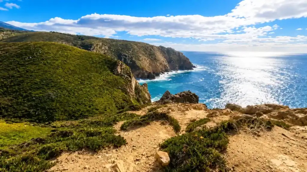 Sunlit Atlantic stretches beyond rugged cliffs along the coastal trail, a top reason to visit Cabo da Roca.