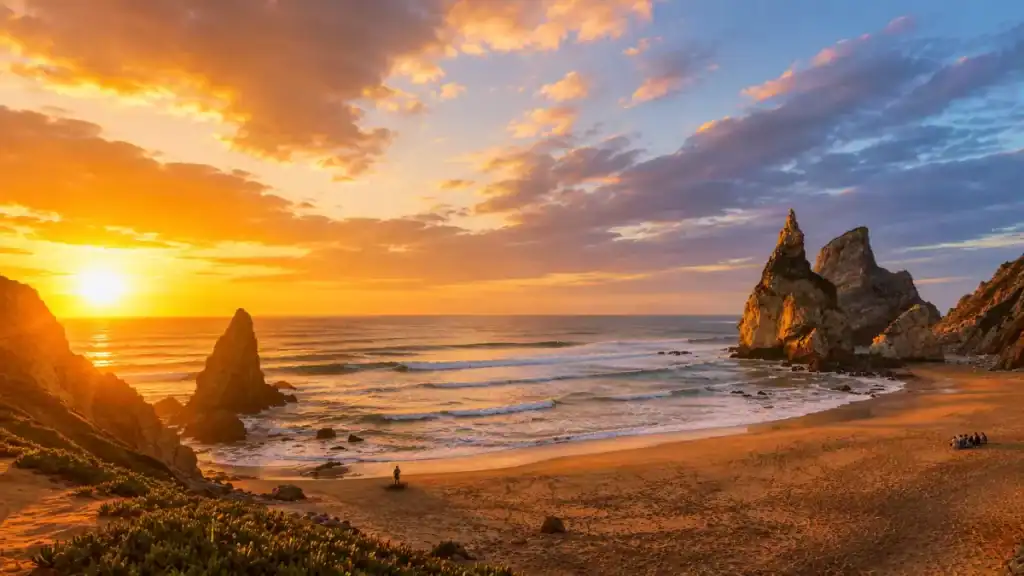 Golden sunset glows over Praia da Ursa's twin sea stacks, a magical place to visit Cabo da Roca.
