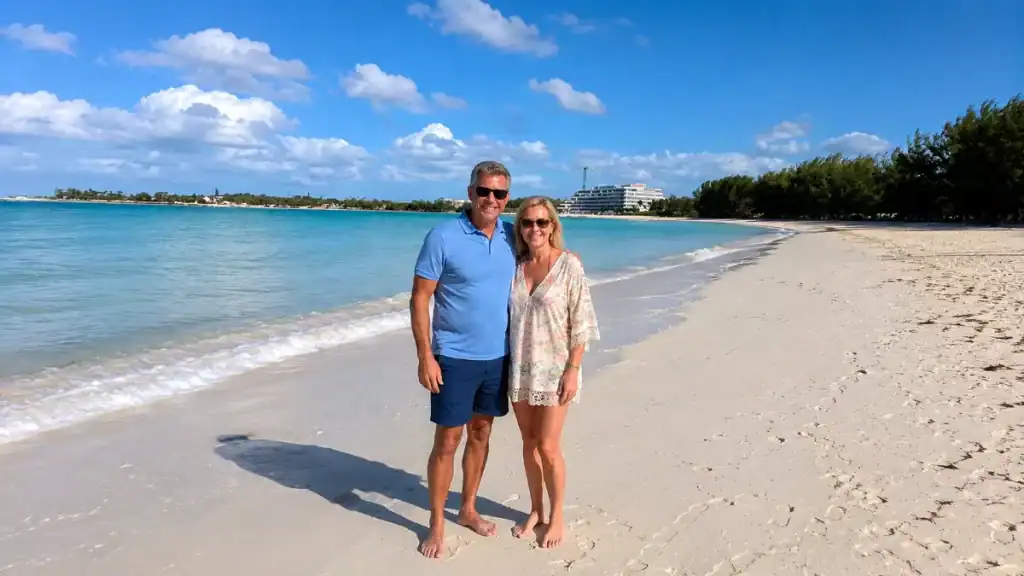 Couple standing barefoot on a quiet white sand beach in Nassau, Bahamas