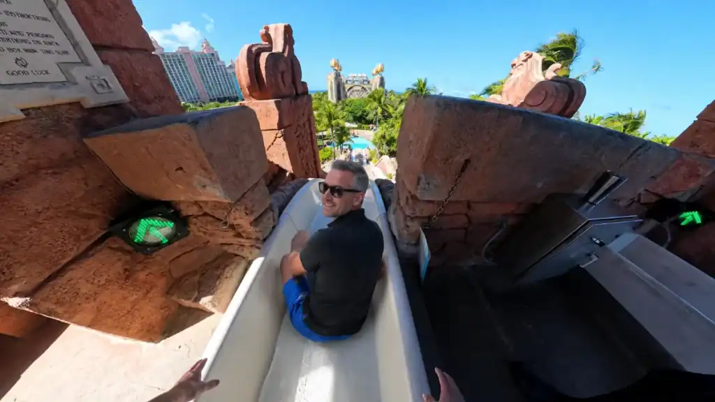 Man smiles atop the Leap of Faith slide at Atlantis Aquaventure