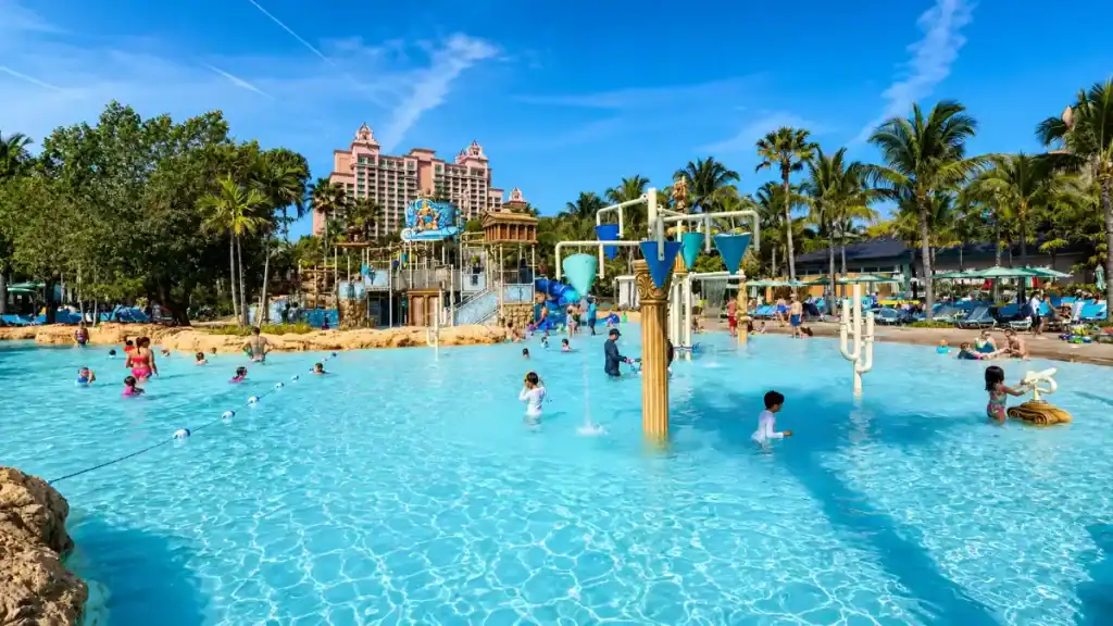 Families splash in a shallow kids pool, another reason is Atlantis Bahamas worth it for families