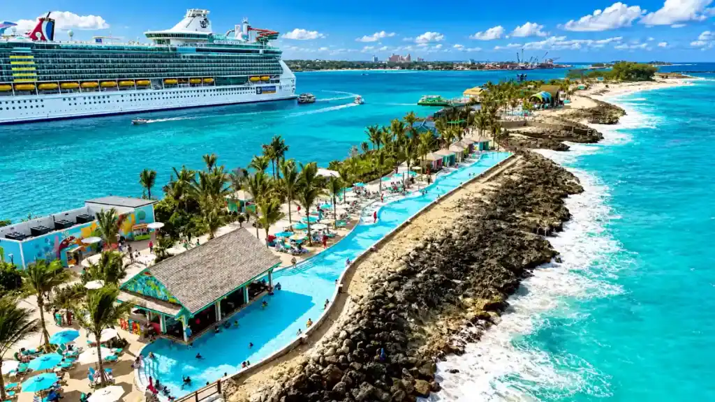 Cruise ship docked near Nassau's rocky coastline with a lazy river below