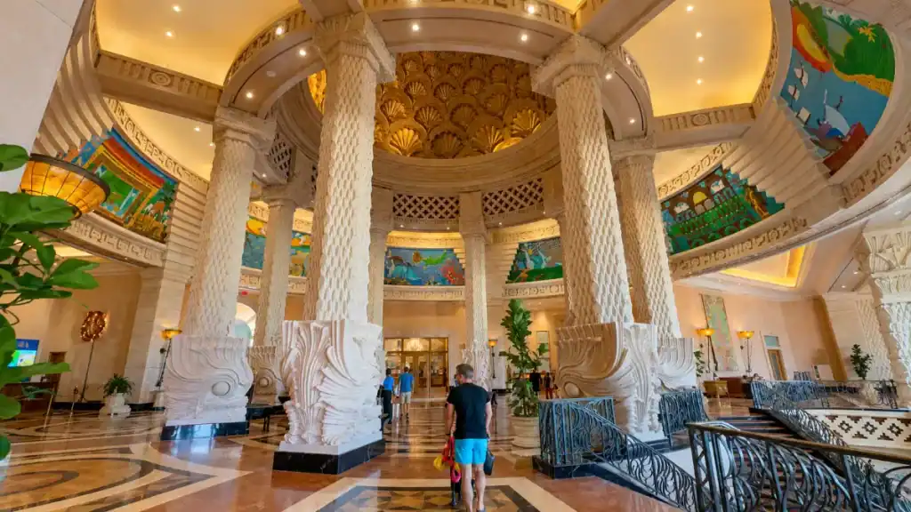 Ornate rotunda lobby with carved columns inside the Atlantis Royal Towers