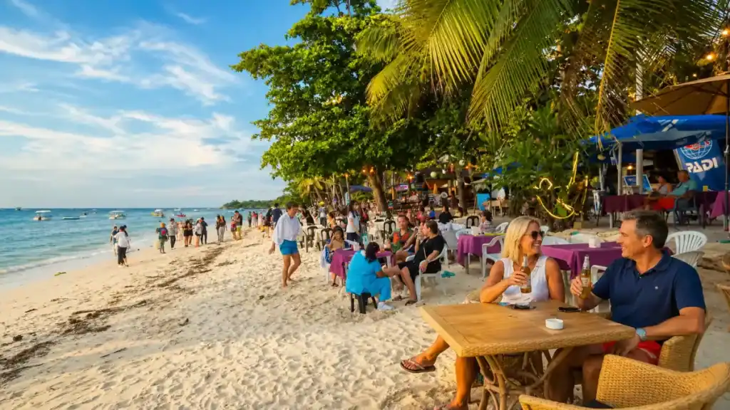 Beachfront diners and strollers along Alona Beach, a lively must on any best Bohol itinerary