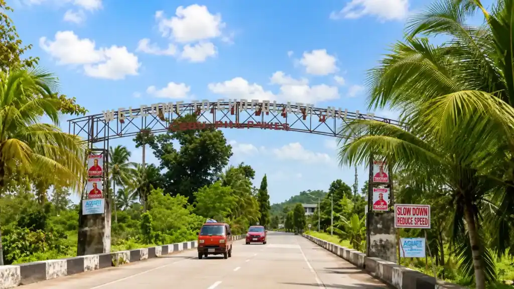 Welcome arch spanning the countryside road leading into Carmen, Bohol