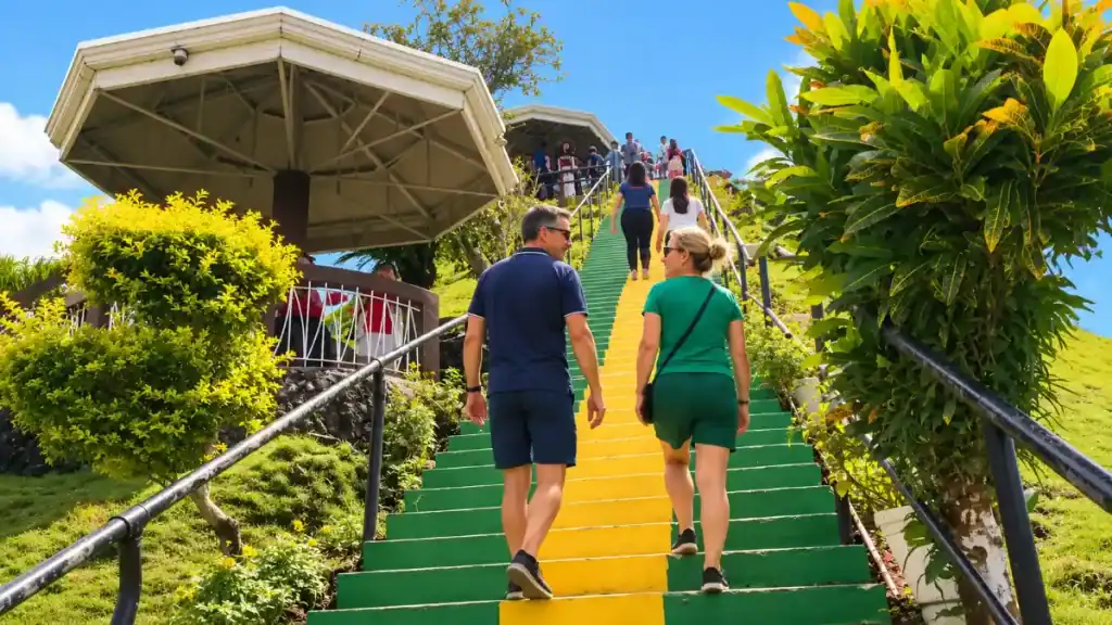 Tourists climb painted steps toward the hilltop lookout shelter in Carmen