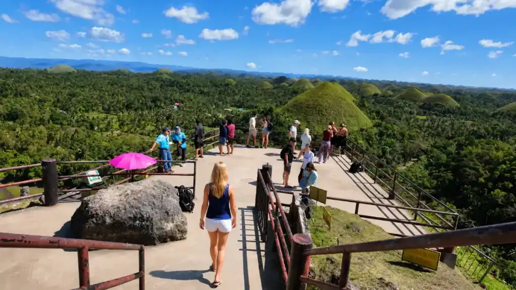 Visitors gather at the elevated lookout deck overlooking the Chocolate Hills near Carmen, Bohol