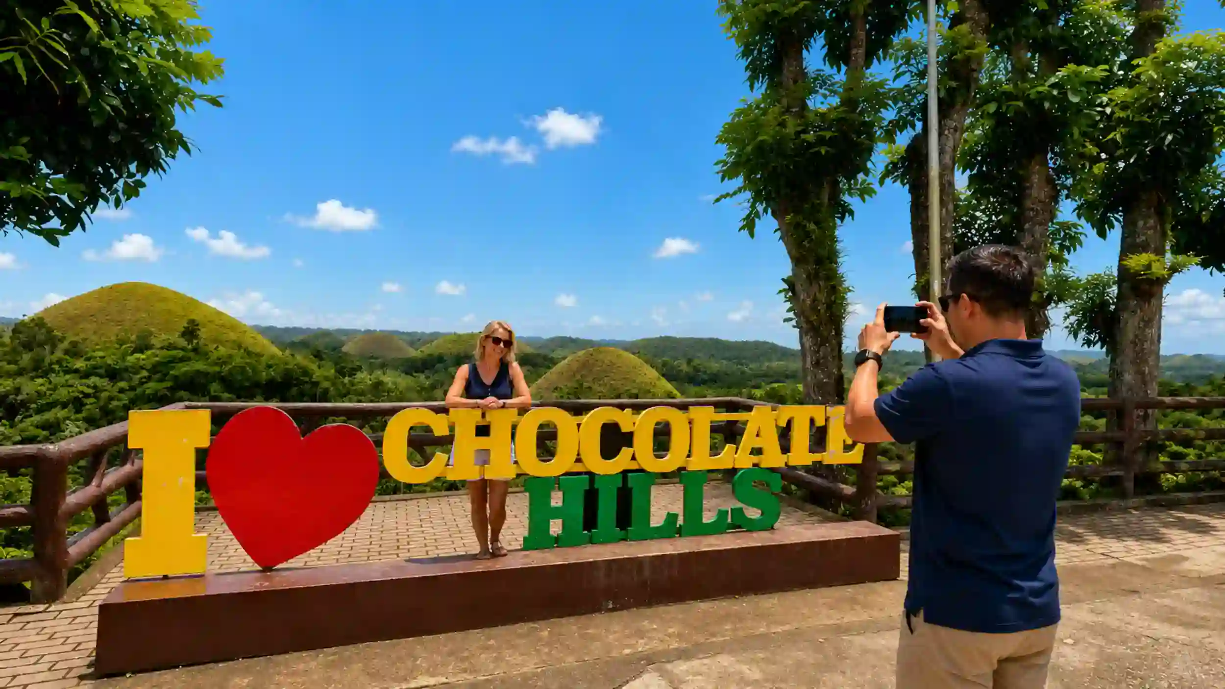 Woman poses at the Chocolate Hills viewpoint, a top stop when planning how many days in Bohol