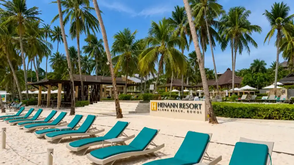 Teal loungers line Alona Beach, a popular resort stop when figuring out how many days in Bohol to spend