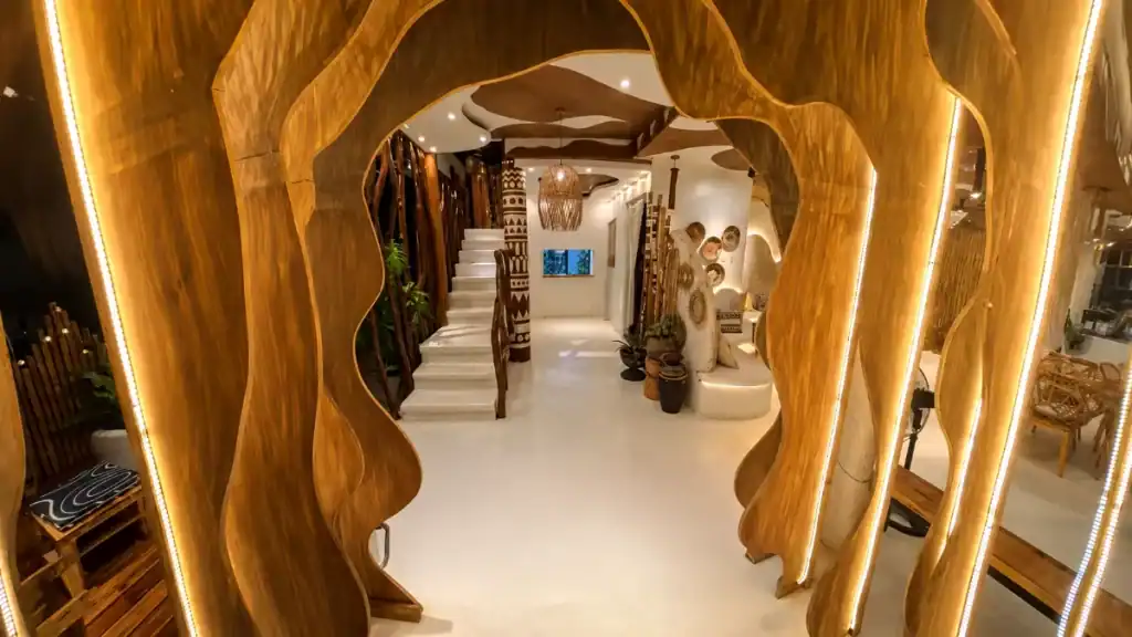 Sculpted wooden archway frames the entrance of a restaurant on Panglao Island
