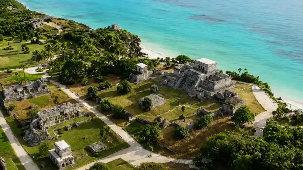 El Castillo temple overlooks turquoise water at the Tulum ruins on Mexico's coastal cliffs.