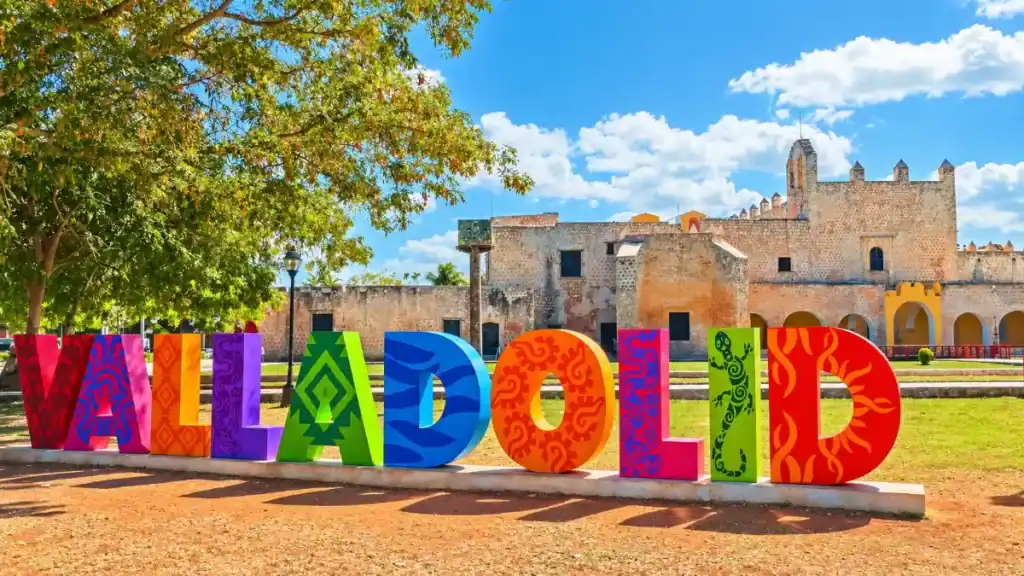 Painted Valladolid letters stand before the colonial convent, a common day trip from Tulum.