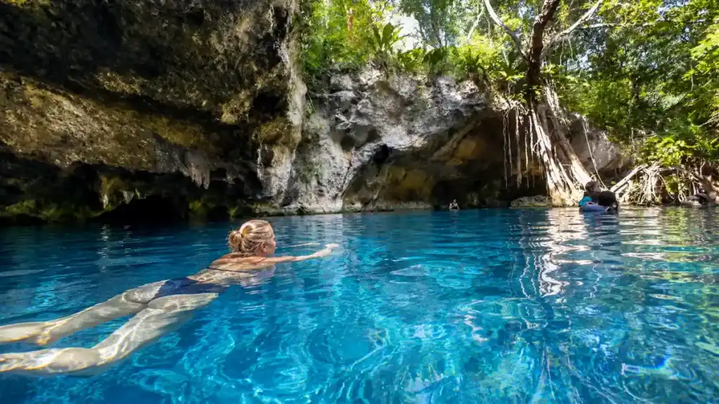 swimmer gliding through Gran Cenote's turquoise waters, a top reason is Tulum worth visiting for nature lovers