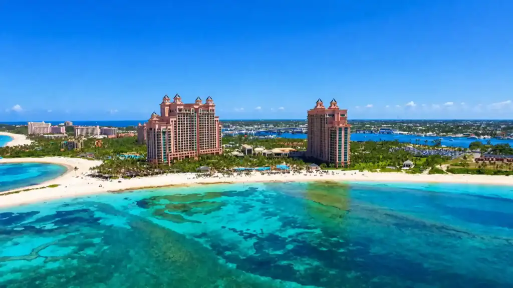Pink twin towers of Atlantis Paradise Island rise above Nassau's turquoise shoreline