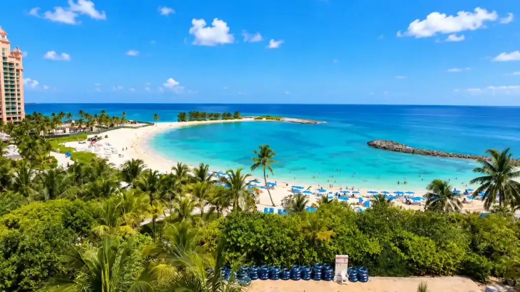 A turquoise cove curls beside Atlantis Paradise Island, one reason travelers weigh how many days in Nassau to spend poolside.