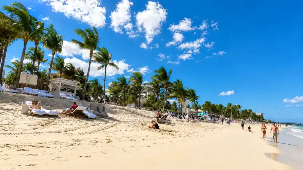 Sun loungers line palm-shaded sand at Cable Beach, a highlight for anyone mapping out how many days in Nassau to book.