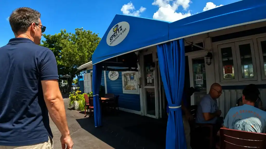 Diners sit under blue awnings at Spritz Restaurant and Bar in Nassau