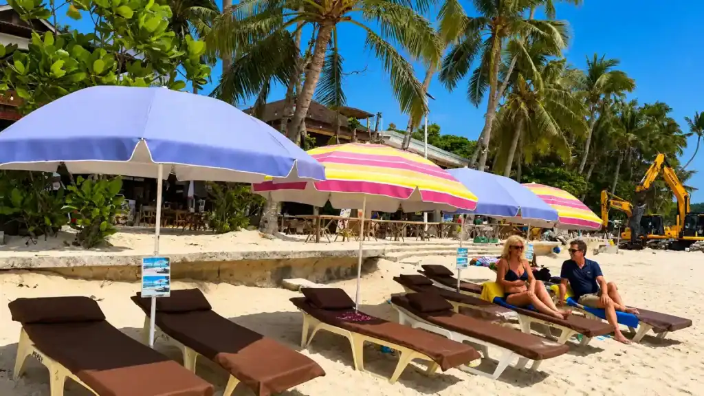 Sun loungers and striped umbrellas fill the sand at Alona Beach in Panglao