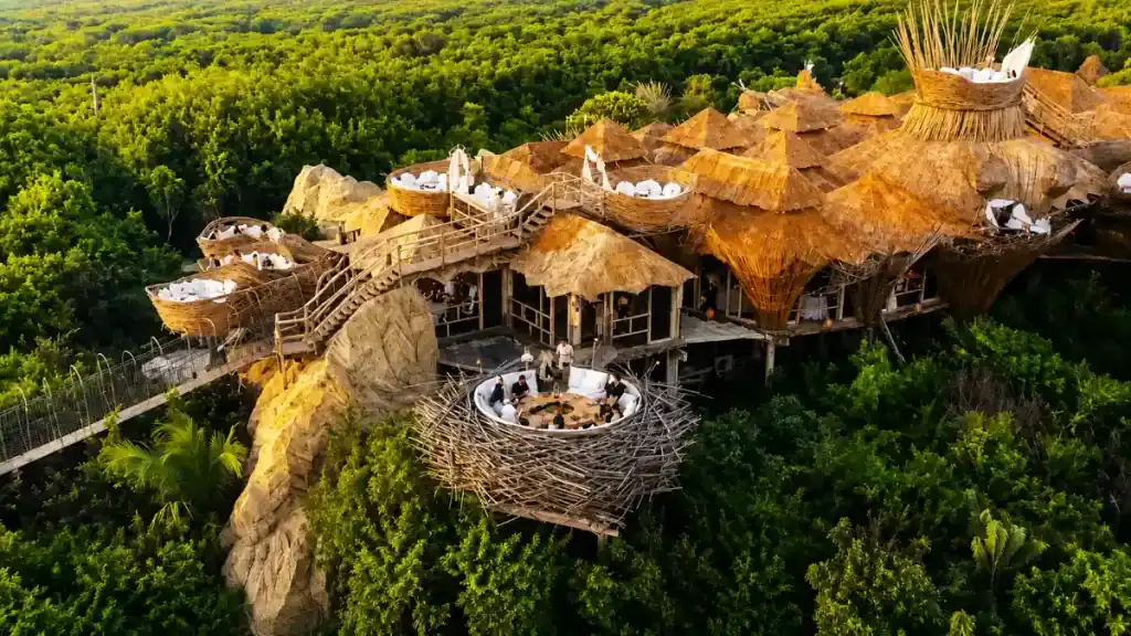 Nest-shaped dining pods at Kin Toh restaurant above Tulum jungle canopy