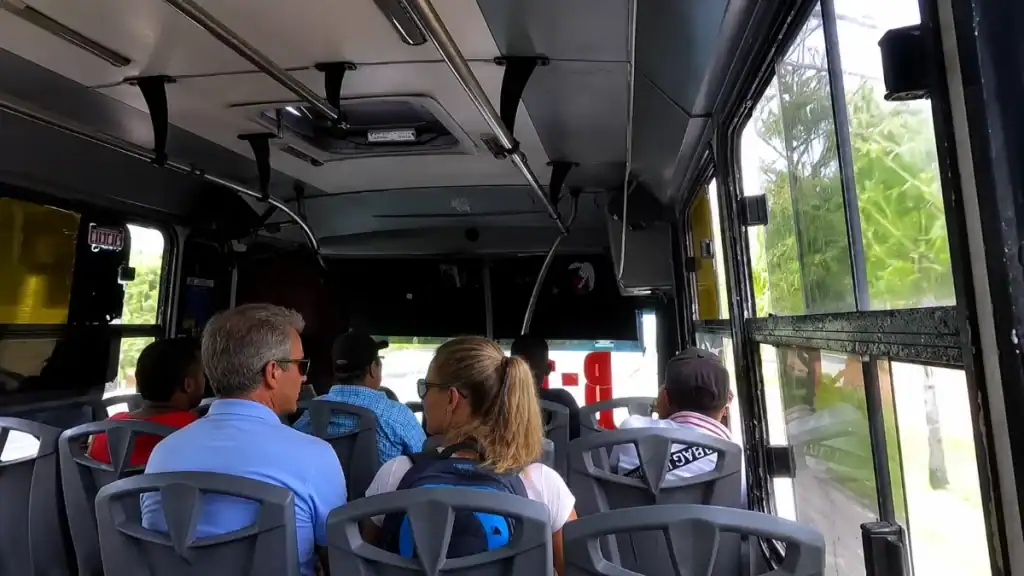 Passengers seated aboard a bus during transfer from Cancún toward the coast