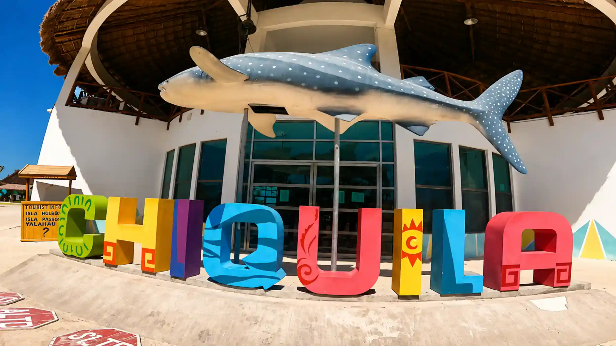 Colorful Chiquilá letters and whale shark sculpture mark the ferry terminal for those researching how to get to Holbox