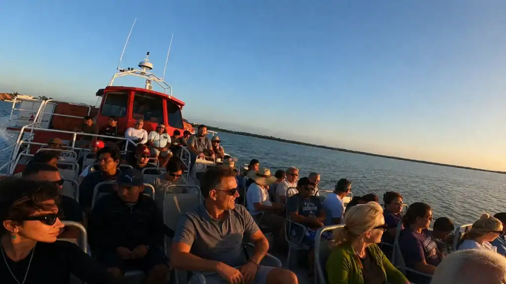 Passengers ride the ferry across Chiquilá channel toward Holbox at dusk