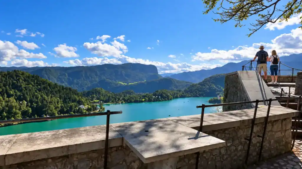 Visitors overlook turquoise Lake Bled from the castle terrace above the water
