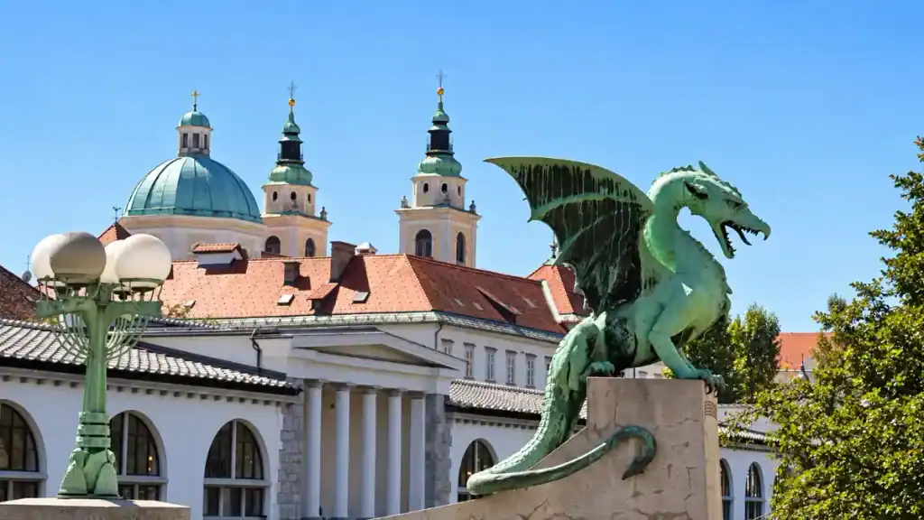 The bronze dragon of Ljubljana's Dragon Bridge perches above the city's baroque rooftops