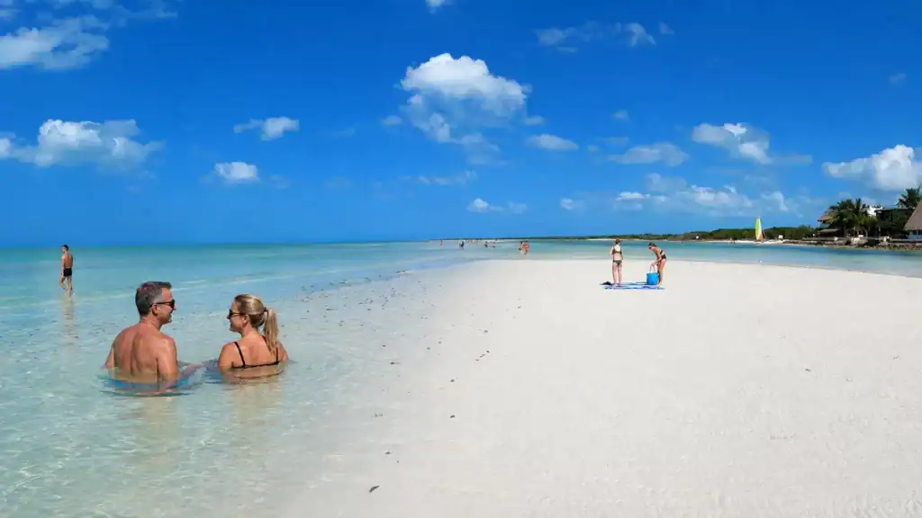 Couple wading in shallow water at the Punta Mosquito sandbar