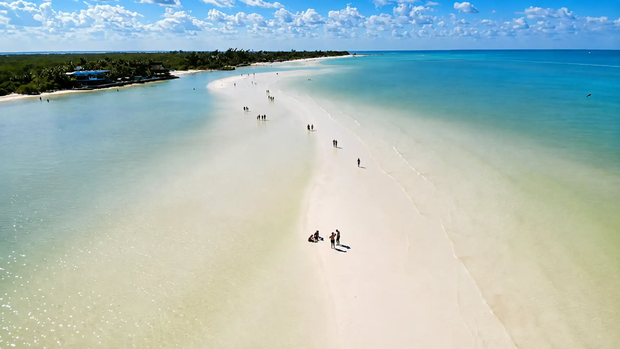 White sand beach curves along Isla Holbox, one of the best spots for where to stay in Holbox