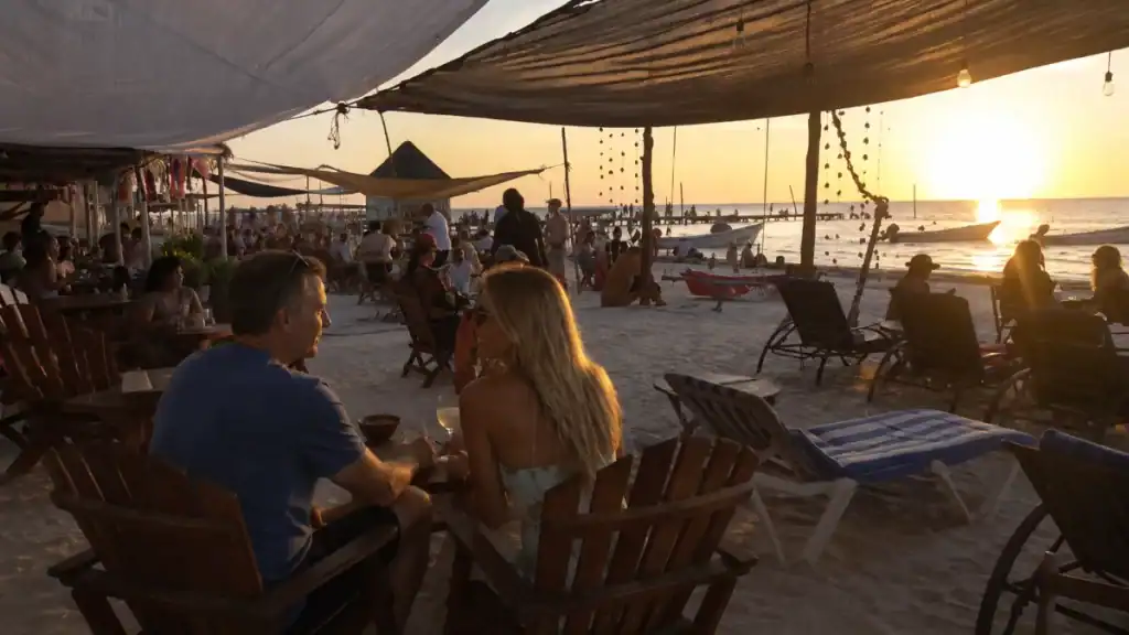 Couple shares drinks at sunset under a canopy at Capitan Capitan beach bar