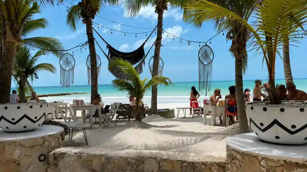 Beachfront lounge with dreamcatchers and hammocks epitomizes where to stay in Holbox for beach access